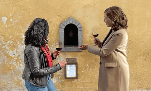 A guide and client at a wine window in Tuscany at a wine tasting tour